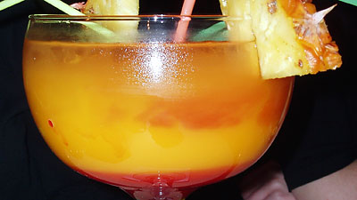 big orange cocktail with pineapple garnish
