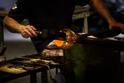 person doing glass-blowing in a workshop