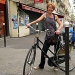 Véronique on Boulevard Voltaire with bike and sacs of purchases.
