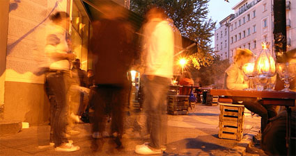 blurry photo of people outside bar