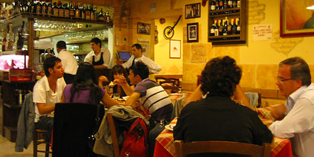 small yellow restaurant interior packed with diners