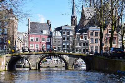 bridge over canal near colorful row houses