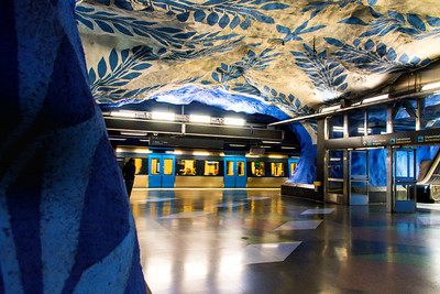 blue and white murals on ceilings and walls of subway station