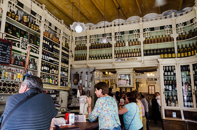 Floor-to-ceiling shelves of alcohol at El Rinconcillo bar in Seville, Spain