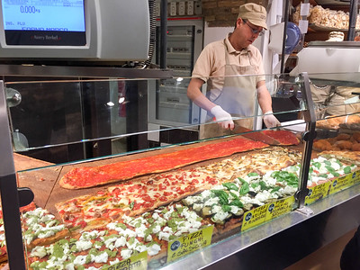 person prepping pizza in Rome
