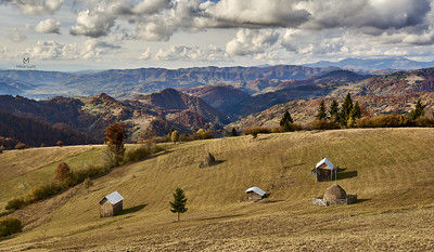rolling hills of farmland with mountains in distance