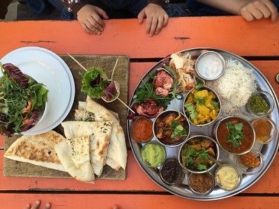 plates of food on orange wood table