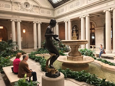 people admiring garden and fountain in Frick Collection