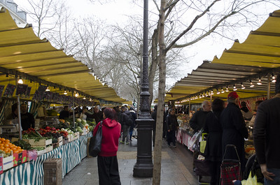 people walking through street market