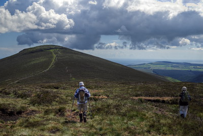 two people hiking mountainous landscape in Ireland