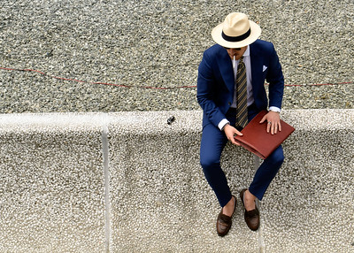 man in nice dress clothes sitting on a step