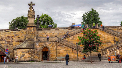 people walking on stone bridge