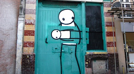 two stick people artworks on blue door