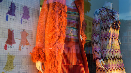 Mannequins in bright outfits in a store window