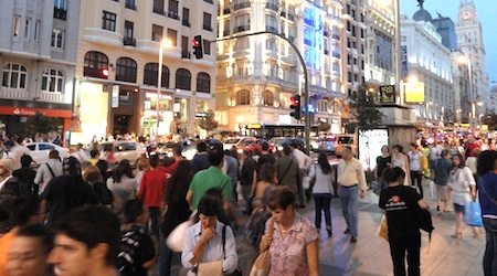 crowds of people walking on Gran Via in Madrid