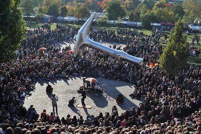 large crowd surrounding person singing karaoke