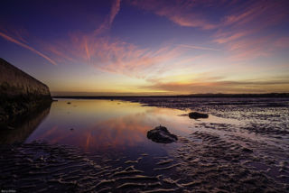 pink and blue sunset sky over a beach