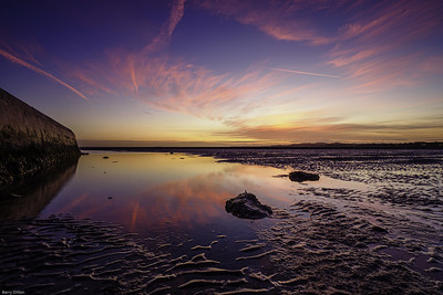 pink and blue sunset sky over a beach