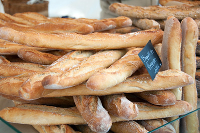 stack of baguettes at Paris food market