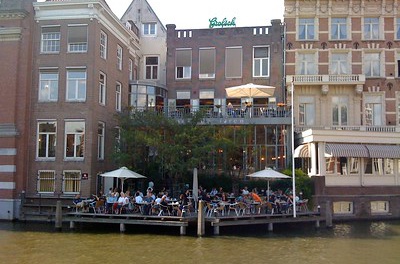 people dining on patio over water in Amsterdam