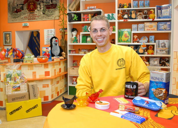 Ostpaket employee with several items on a table