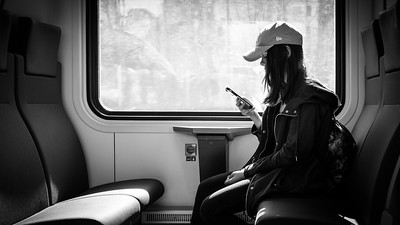 person checking phone while on train