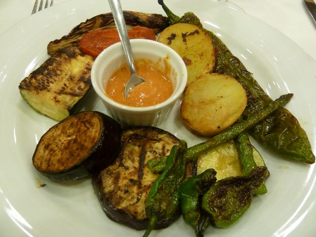 Eating Roasted Vegetables with Romesco Sauce in Barcelona, Spain