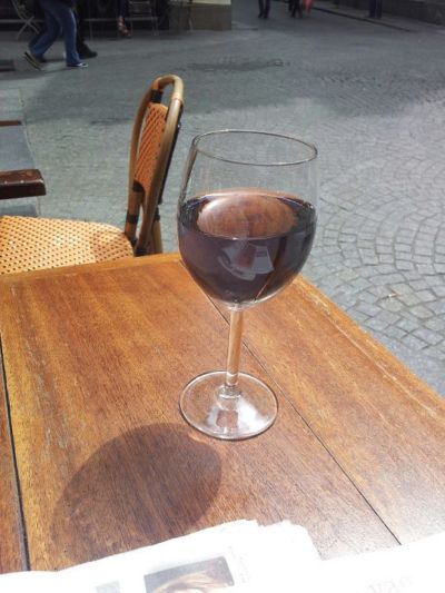 purple kir in glass on wood table