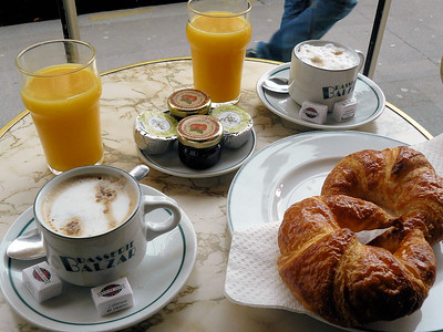 lattes and croissants on outdoor table