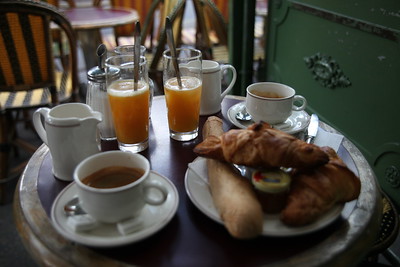 pastries, coffee and fresh juice on restaurant table