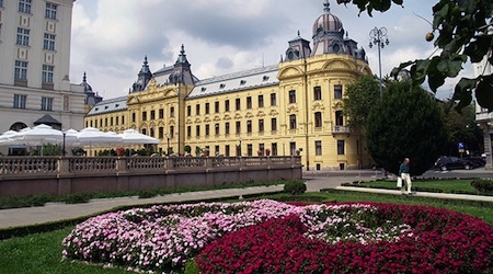 old building and pink flowers in Zagreb