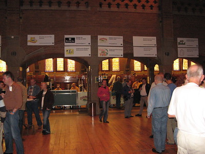people drinking beer in small brick building