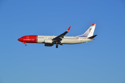 Norwegian Air plane against blue sky