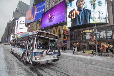 MTA bus driving through snowy Manhattan