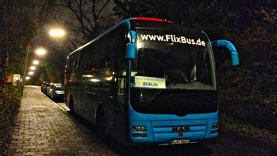 blue bus parked at night