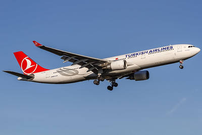Turkish Airways plane flying through blue skies