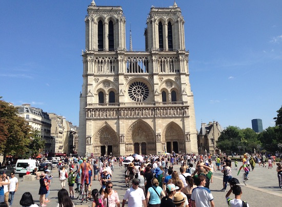 Summer travel means long lines in Paris, including outside Notre Dame. 