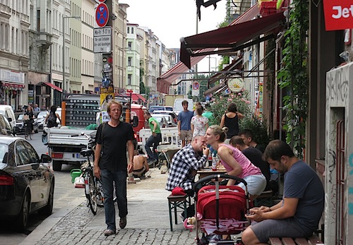 people sitting at outdoor dining tables on Oranienstrasse