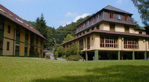 tan and green exterior of Hotel Scheid in Heidelberg, Germany
