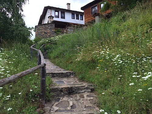 A stone path winds its way up to the Kosovo Houses. 