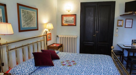 blue floral bed in white hotel room