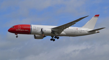Norwegian 787 Dreamliner flying through blue skies