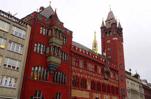 bright red city hall building with ornate balconies