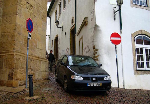 Portugal car driving out of small alley