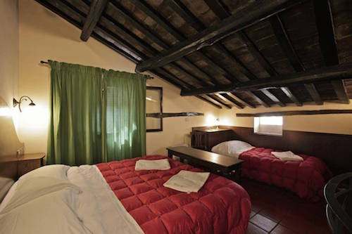 A family room with original wood ceilings at Hotel Panda.