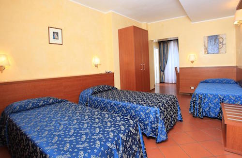 A triple room is a comfy home base for families at Casa Di Santa Francesca Romana a Ponte Rotto.