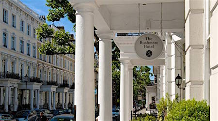 White hotel with columns and sign that reads "Rushmore Hotel"