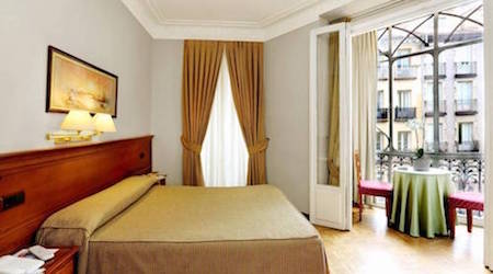 gold and white hotel room inside Hostal La Macarena