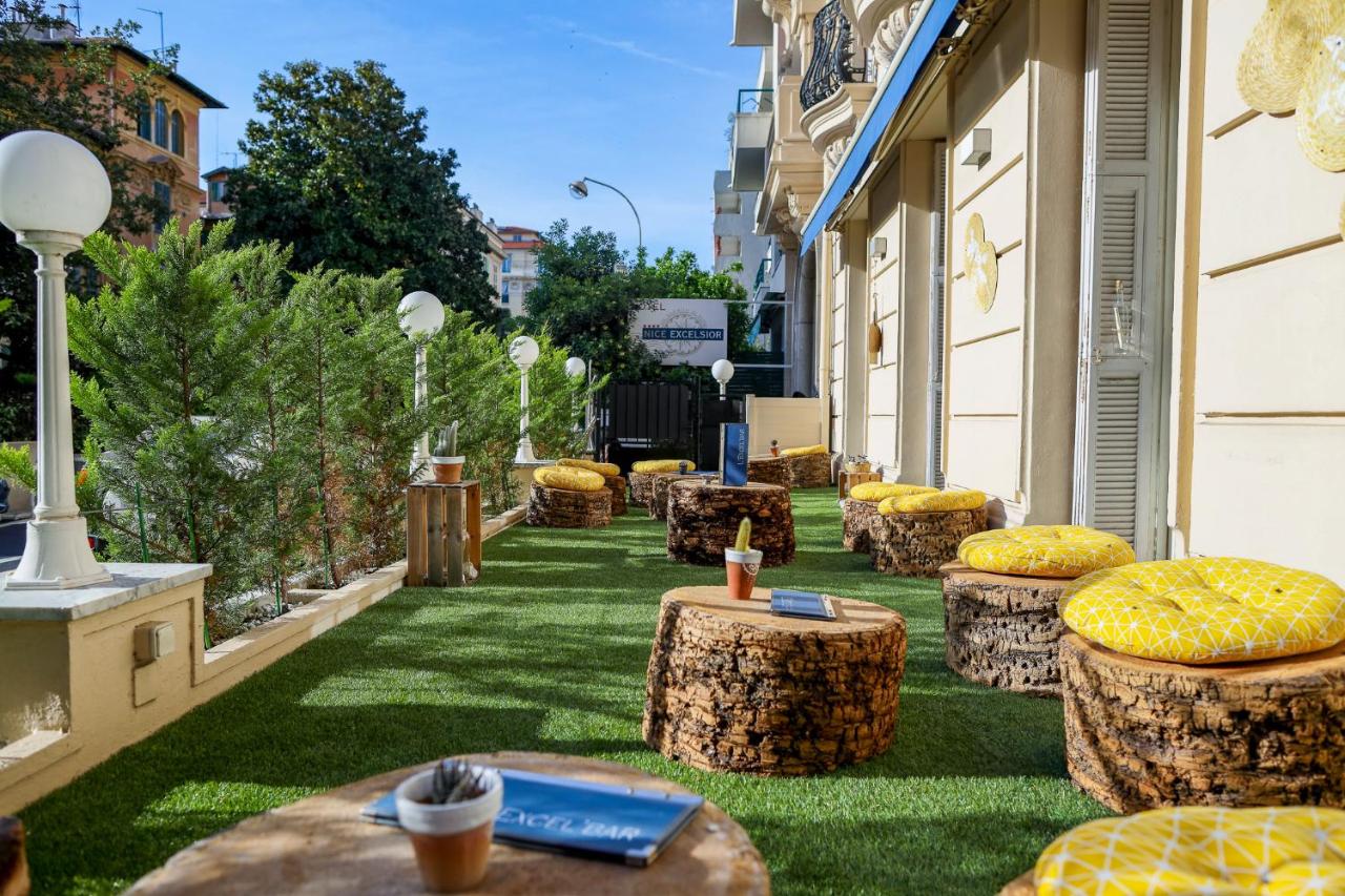 hotel Excelsior patio with faux wood stump stools and tables