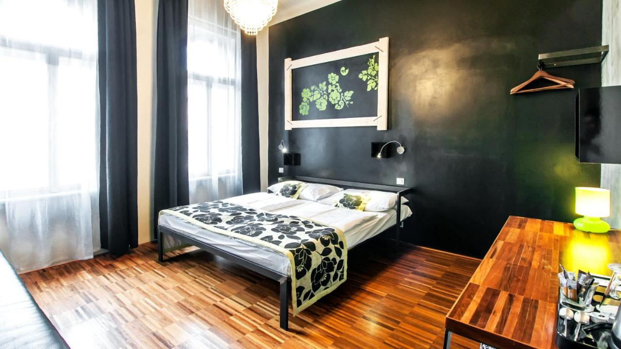 hotel room at Czech Inn decorated with black walls and black and green decor